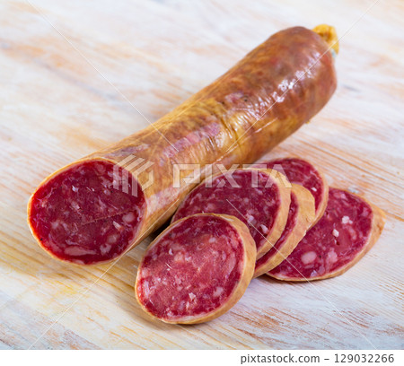 Appetizing salchichon sausage on wooden table Appetizing salchichon sausage on wooden table 129032266