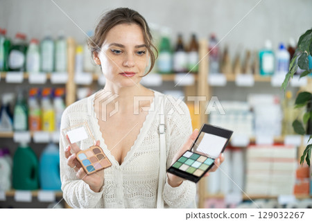 Young woman choosing cosmetics in supermarket Young woman choosing cosmetics in supermarket 129032267