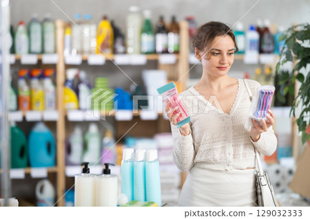 Housewife purchases household chemicals in store and chooses razor 129032333
