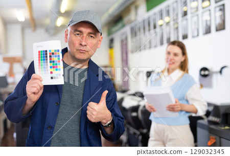 Man publishing facility worker with colour test page 129032345