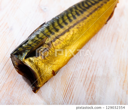 Smoked mackerel on wooden background Smoked mackerel on wooden background 129032354