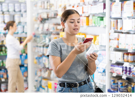 Young woman looking for remedy from photo on internet 129032414