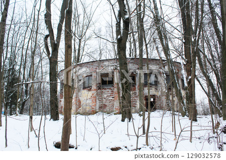 An old abandoned building in winter among the trees. Abandoned building. 129032578