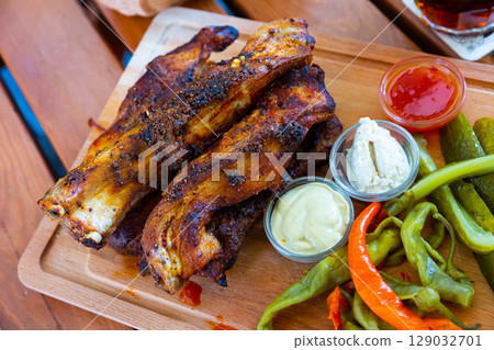 Baked pork ribs with pickled pepper, cucumbers, horseradish and mustard. Czech cuisine 129032701