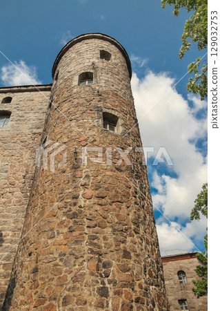 Old brown Olaf's Tower in city Vyborg, Russia on sunny day, view from below Old brown Olaf's Tower in city Vyborg, Russia on sunny day, view from below 129032753