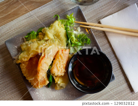 Tempura with vegetables in batter. Japanese cuisine Tempura with vegetables in batter. Japanese cuisine 129032812