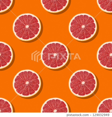Seamless pattern of colorful citrus slices on orange background. Creative fruits concept. Colorful grapefruit food background. 129032949