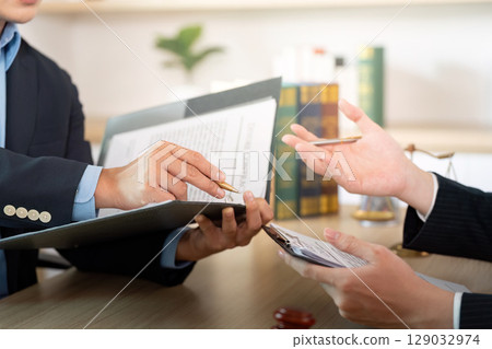 Document Review. Lawyer discussing legal papers with a client. Document Review. Lawyer discussing legal papers with a client. 129032974