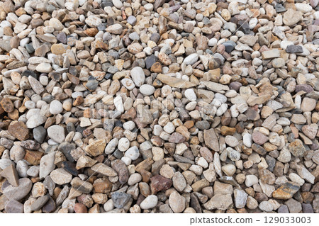 Close-Up of Natural Multicolored River Rocks in a Pile 129033003