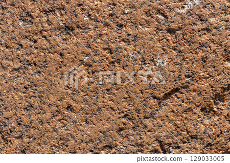 Close-Up Texture of Brown Rough Granite Rock Surface 129033005