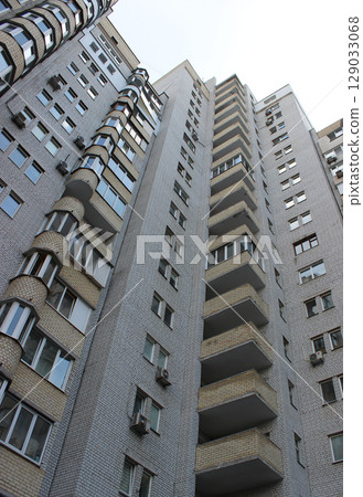 Balconies and windows on a facade brick multi storey apartments low point view  129033068