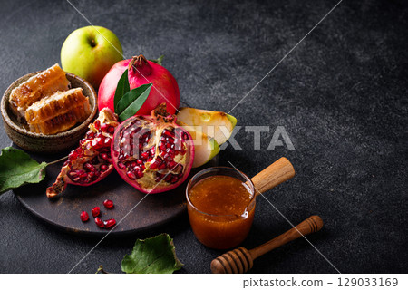 Rosh Hashana concept with honey, apple and pomegranate Rosh Hashana concept with honey, apple and pomegranate 129033169
