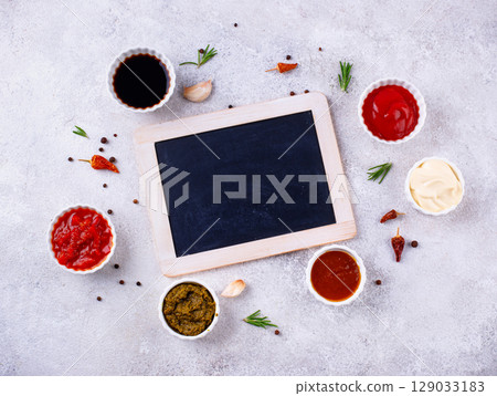 Set of different sauces. Ketchup, mustard, pesto 129033183