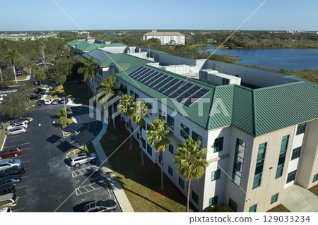 Top view of residential condo in USA with rooftop covered with solar photovoltaic panels for producing of clean ecological electrical energy. Concept of autonomous home 129033234