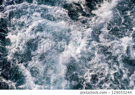 Top down aerial view of sea water surface. White foam waves texture as natural background. 129033244