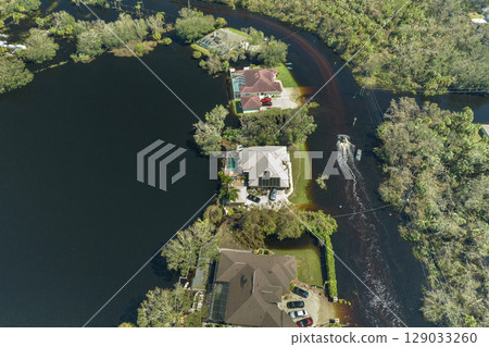 Surrounded by hurricane Ian rainfall flood waters homes in Florida residential area. Aftermath of natural disaster Surrounded by hurricane Ian rainfall flood waters homes in Florida residential area. Aftermath of natural disaster 129033260