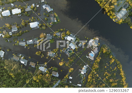 Surrounded by hurricane Ian rainfall flood waters homes in Florida residential area. Aftermath of natural disaster Surrounded by hurricane Ian rainfall flood waters homes in Florida residential area. Aftermath of natural disaster 129033267