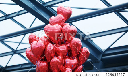 Tied Red Heart-Shaped Balloons 129033317