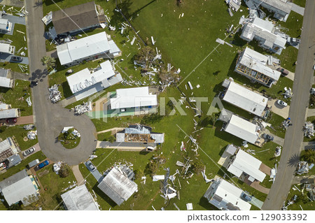 Severely damaged by hurricane Ian houses in Florida mobile home residential area. Consequences of natural disaster 129033392