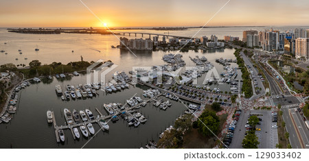 Sarasota, Florida at sunset. USA travel destination. Yachts docked in Sarasota Bay marina. American waterfront city downtown architecture Sarasota, Florida at sunset. USA travel destination. Yachts docked in Sarasota Bay marina. American waterfront city downtown architecture 129033402