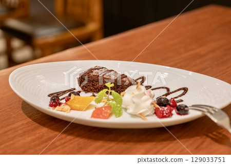Cafe gateau chocolat and colorful fruit platter Cafe gateau chocolat and colorful fruit platter 129033751