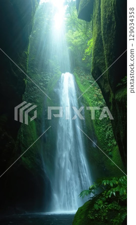 Majestic waterfall pouring into lush green canyon. Powerful vertical nature composition for mobile wallpaper. Generative AI. 129034358