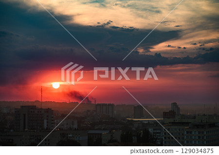 Dramatic sunset sky over city skyline with clouds. Dramatic sunset sky over city skyline with clouds. 129034875