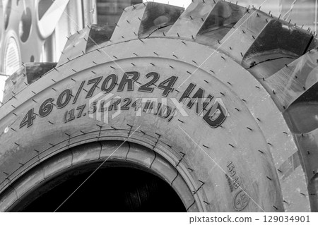 Close-up of Industrial Tire with Size Marking in Black and White Macro Detail View Close-up of Industrial Tire with Size Marking in Black and White Macro Detail View 129034901