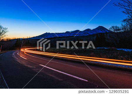 Shiretoko Mountains and car light trails at dawn Shiretoko Mountains and car light trails at dawn 129035291