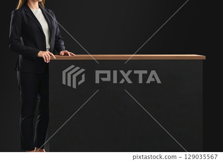 Woman standing near black promo counter mockup, ai generated Woman standing near black promo counter mockup, ai generated 129035567