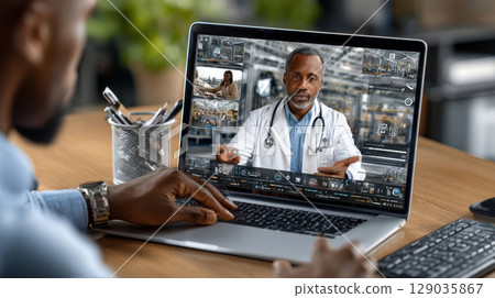Virtual healthcare consultation with doctor via laptop on wooden desk 129035867