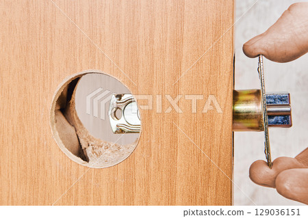 Latch mechanism being inserted into precut hole on door edge aligning with round bore for further knob installation and locking function. Latch mechanism being inserted into precut hole on door edge aligning with round bore for further knob installation and locking function. 129036151