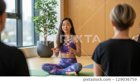 Yoga Instructor Leading a Class in a Bright Studio - AI generated image Yoga Instructor Leading a Class in a Bright Studio - AI generated image 129036759