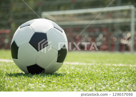Soccer Ball on Field in Front of Goal Post Soccer Ball on Field in Front of Goal Post 129037098