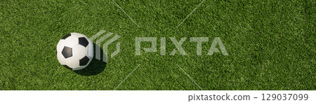 Soccer Ball on Green Grass Field with White Corner 129037099
