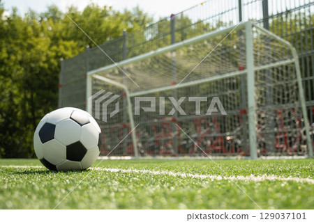 Soccer Ball on Field in Front of Goal Post Soccer Ball on Field in Front of Goal Post 129037101