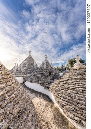 Alberobello trulli rooftops, Puglia, Italy, showcasing unique architecture and cultural heritage.. Alberobello trulli rooftops, Puglia, Italy, showcasing unique architecture and cultural heritage.. 129037207
