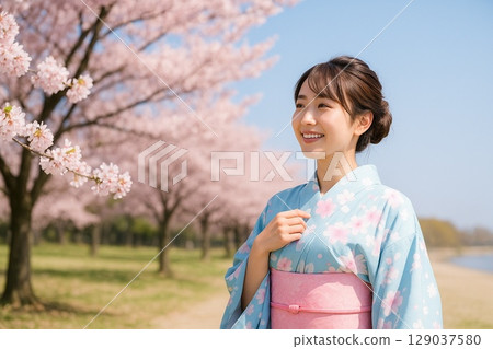 Cherry blossoms in full bloom and a young woman in a kimono 129037580