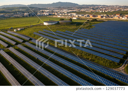 Solar panel farm located in a rural area with Solar panel farm located in a rural area with 129037773