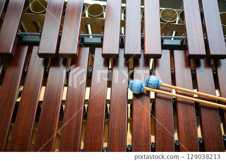 A marimba and blue mallets placed on top 129038213