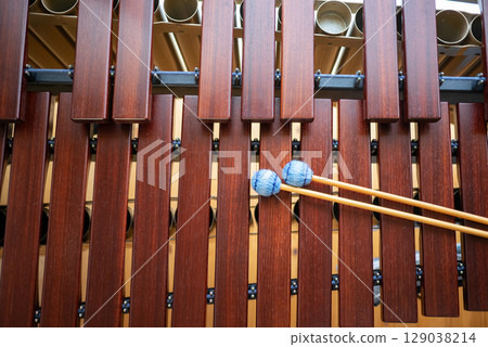 A marimba and blue mallets placed on top 129038214