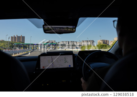 A car with a navigation system running on a highway 129038518