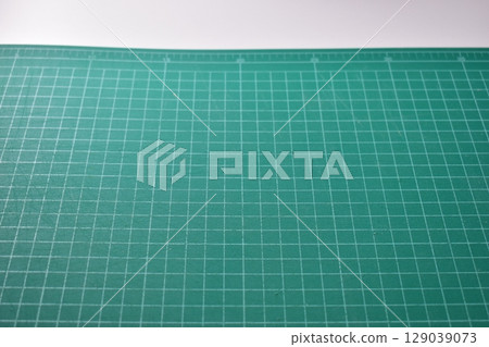 green cutting mat board on white background with line and scale measure guide pattern for object art design, tool equipment of diy craft work green cutting mat board on white background with line and scale measure guide pattern for object art design, tool equipment of diy craft work 129039073