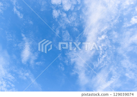 beautiful blue sky and white fluffy group of clouds with sunrise in the morning, natural background beautiful blue sky and white fluffy group of clouds with sunrise in the morning, natural background 129039074