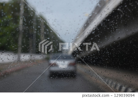 car on highway road with rainny season, blurred image 129039094