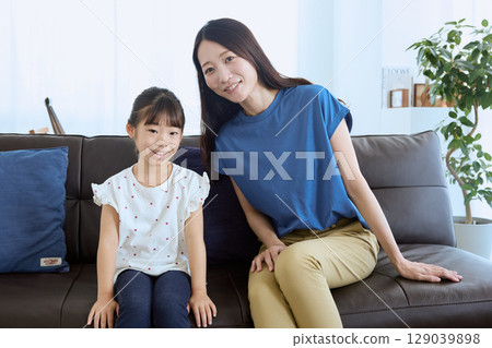 Mother and daughter having a fun conversation in the living room – Homely Mother and daughter having a fun conversation in the living room – Homely 129039898