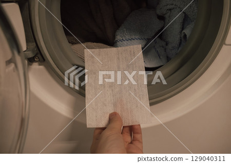 Concept of using dye-catcher sheet for washing multicoloured clothes 129040311