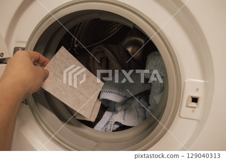 Color-catching sheet before being placed into the washing machine drum 129040313