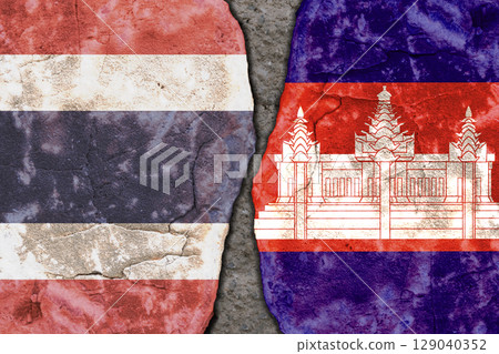Symbolic split between Thailand and Cambodia flags on cracked stone wall texture Symbolic split between Thailand and Cambodia flags on cracked stone wall texture 129040352