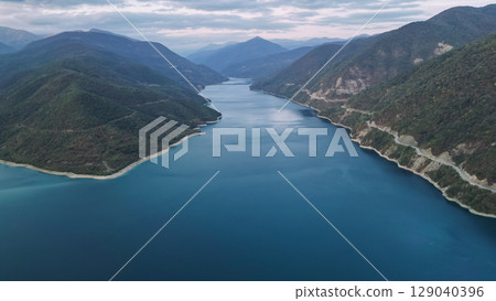 Zhinvali Reservoir in Georgia, scenic lake surrounded by green mountains and forests Zhinvali Reservoir in Georgia, scenic lake surrounded by green mountains and forests 129040396